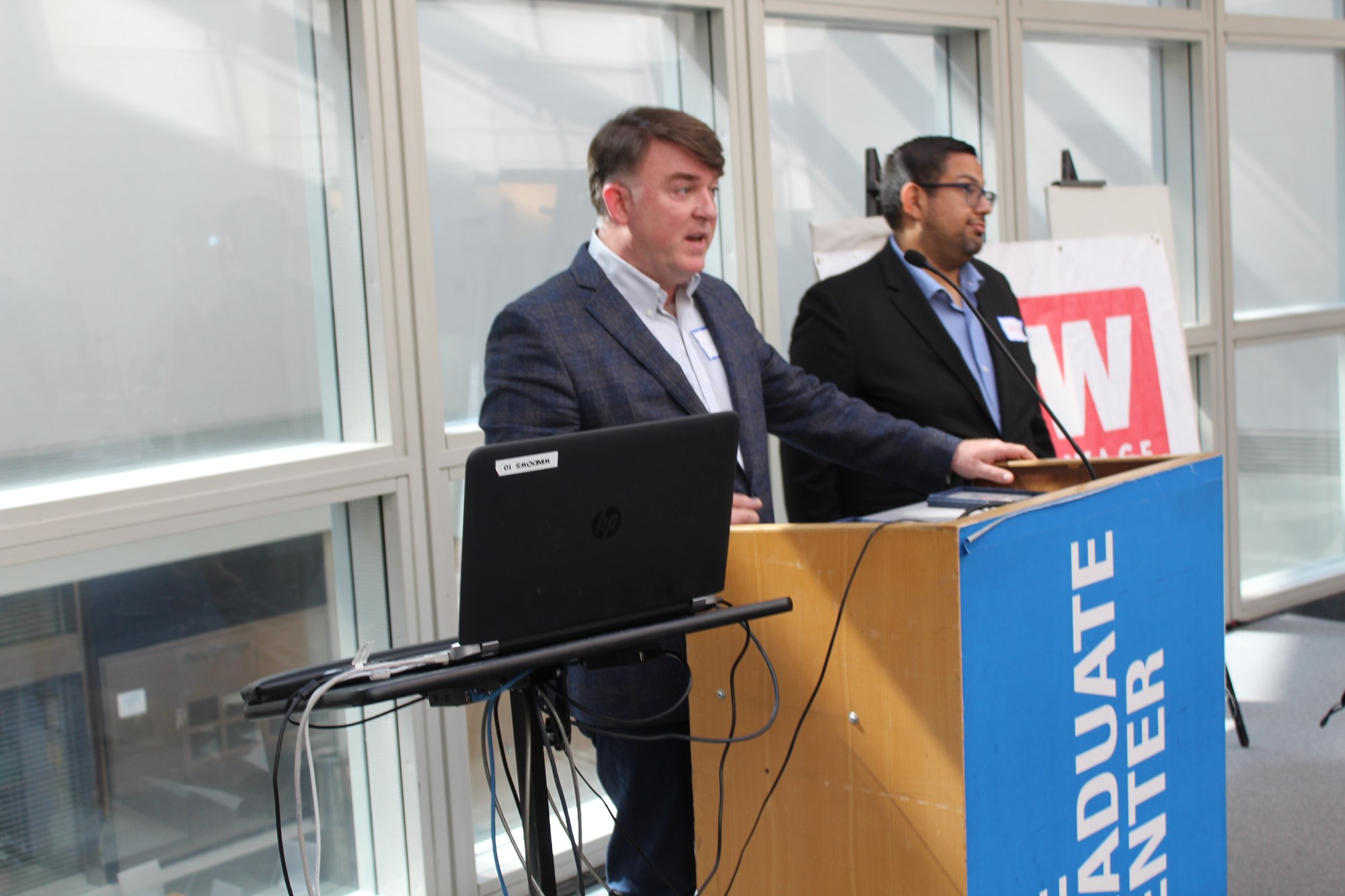 Michael Fuquay, Owner of The Queensboro in Queens, NY, speaking at the podium at an OFW event