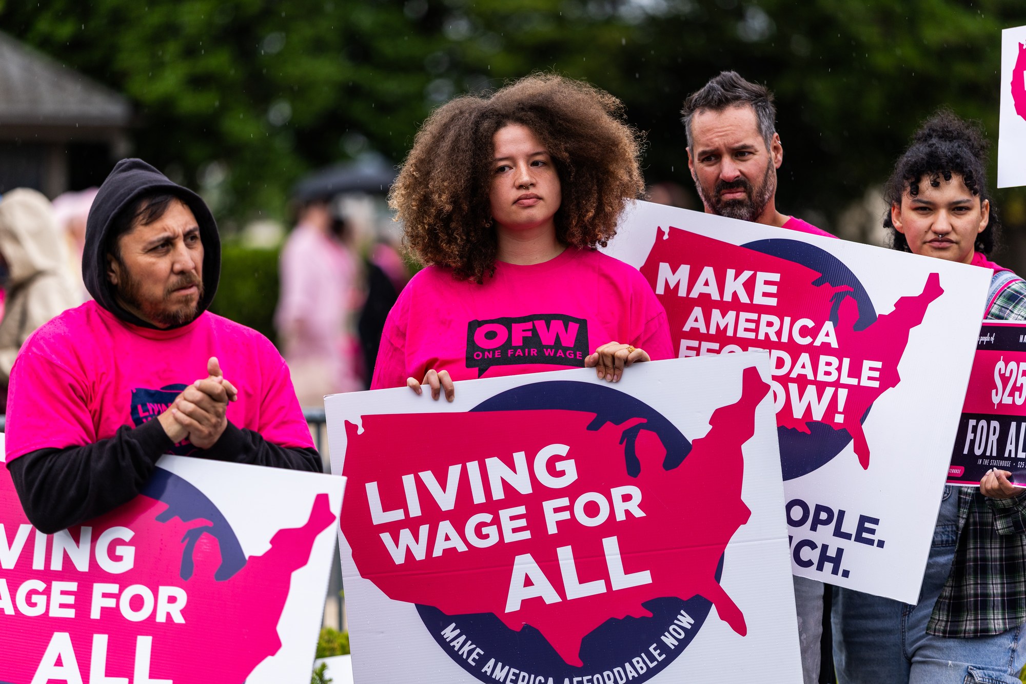 Illinois restaurant workers in pink One Fair Wage shirts holding signs at the U.S. Capitol